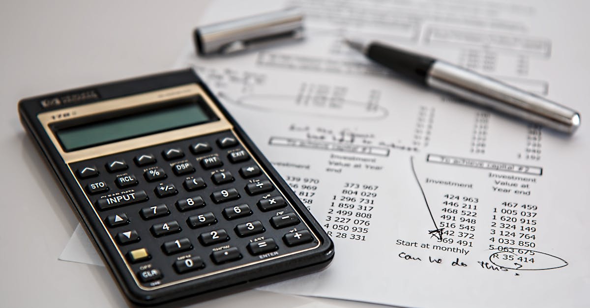 Close-up of financial documents with calculator and pen, ideal for business management themes.