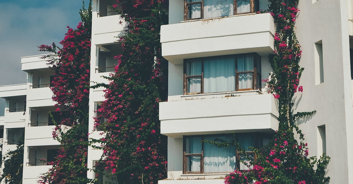 Modern apartment buildings with lush vines climbing the facade, creating a vibrant urban aesthetic.