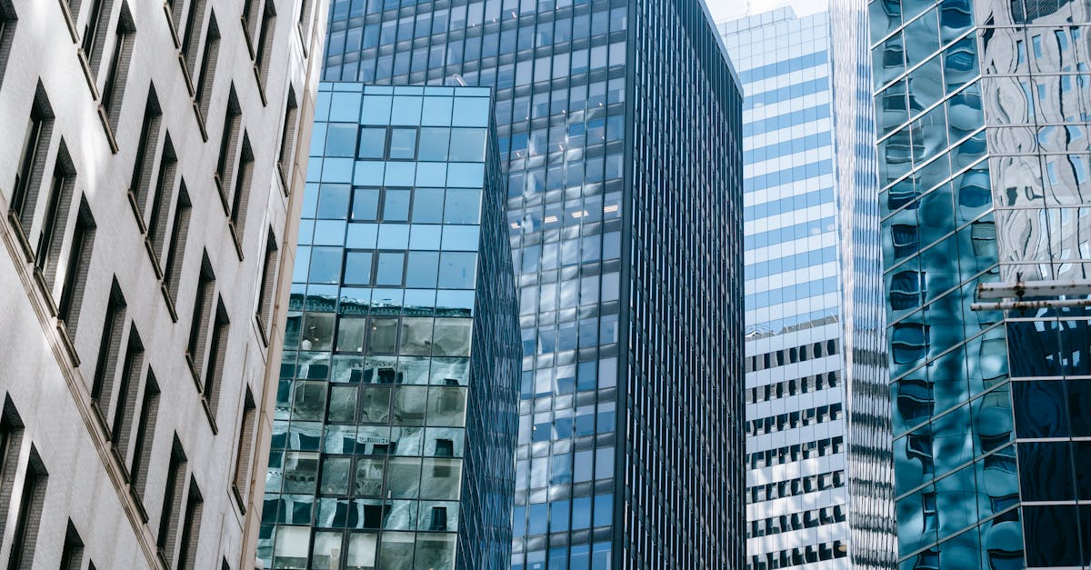 Contemporary skyscrapers with glass facades in a vibrant cityscape during the day.